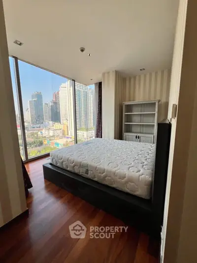 Spacious bedroom with city view and modern furnishings