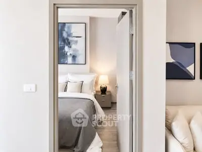 Modern bedroom with stylish decor and cozy ambiance, featuring elegant artwork and soft lighting.
