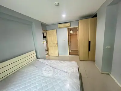 Spacious bedroom with modern wardrobe and air conditioning in a stylish apartment.