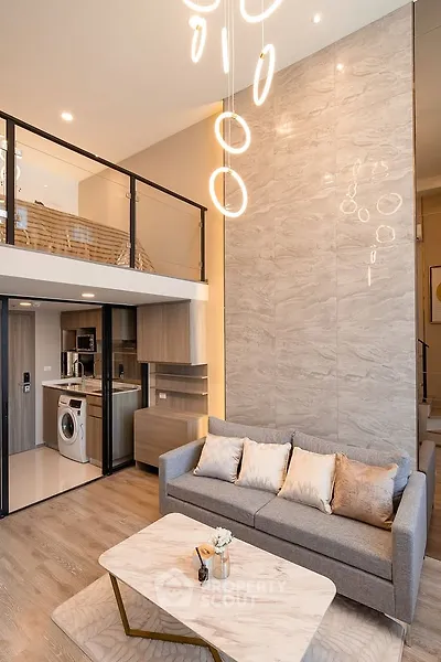 Modern loft apartment with stylish living room and mezzanine, featuring elegant lighting and contemporary decor.