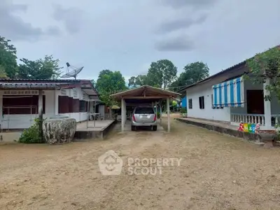 Charming rural property with carport and spacious yard, ideal for serene living.