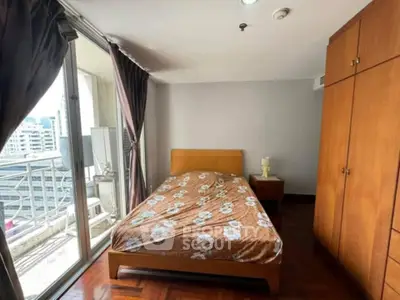 Cozy bedroom with balcony view in urban apartment