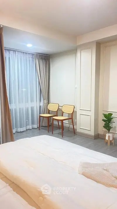 Elegant bedroom with cozy seating area and soft lighting