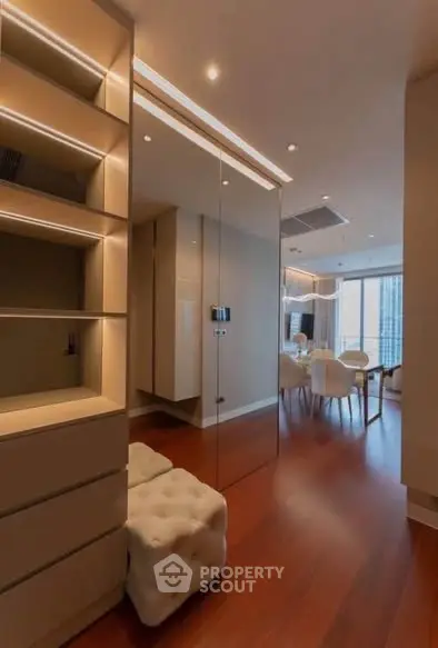 Modern living room with elegant dining area and wooden flooring