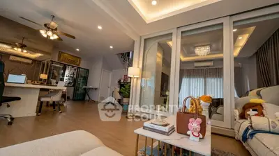 Luxurious living room with elegant decor and spacious layout, featuring modern lighting and stylish furnishings.