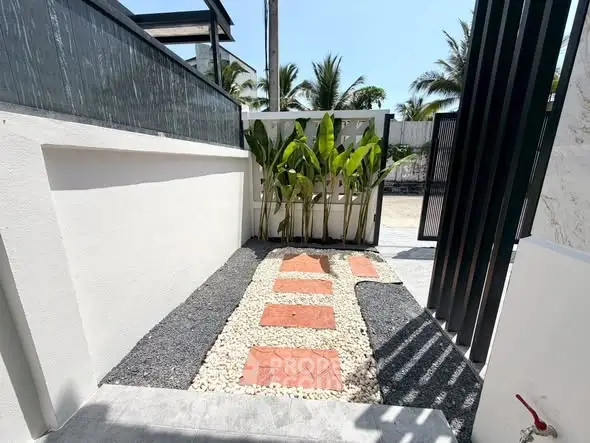 Charming garden path with stepping stones and lush greenery in a modern outdoor space.