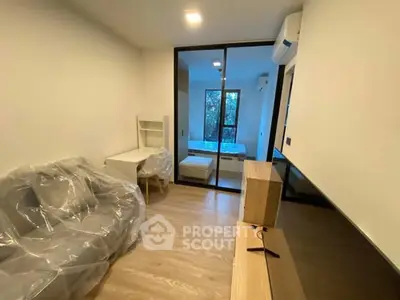 Modern apartment interior with glass partition and wooden flooring