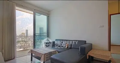 Modern living room with city view and cozy sofa in high-rise apartment