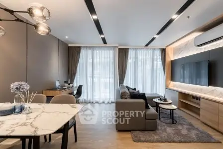 Modern living room with stylish decor, large windows, and cozy seating area in a contemporary apartment.