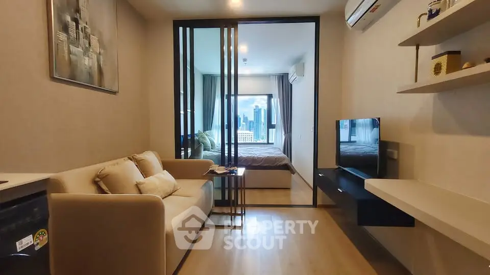 Modern condo interior with cozy living room and bedroom, featuring city skyline view.