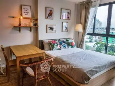 Charming bedroom with city view, stylish decor, and natural light, perfect for urban living.
