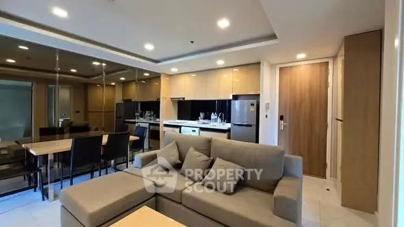 Modern living room with open kitchen layout and stylish furniture in a contemporary apartment.