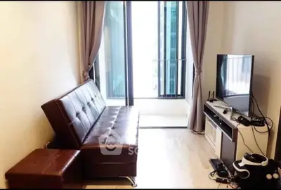 Modern living room with leather sofa and large window in high-rise apartment