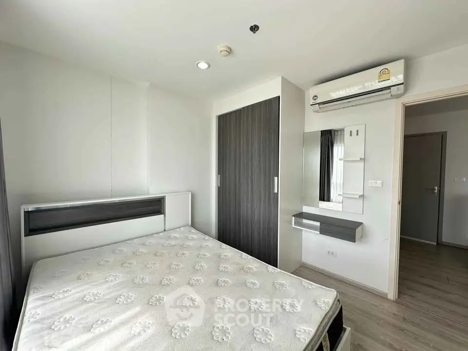 Modern bedroom with sleek design and built-in wardrobe in a stylish apartment.