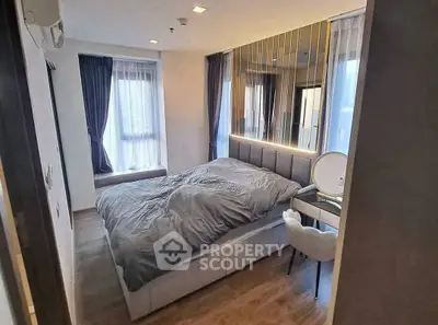 Modern bedroom with stylish decor and large windows for natural light