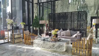 Luxurious modern living room with marble floors and stylish decor in a high-end property.