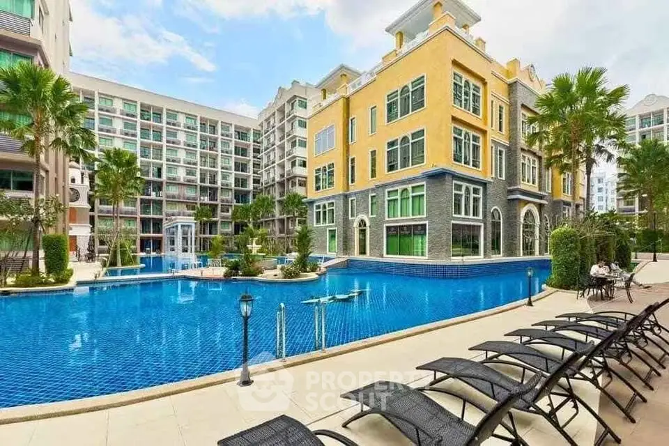 Luxurious residential complex with stunning poolside view and modern architecture.