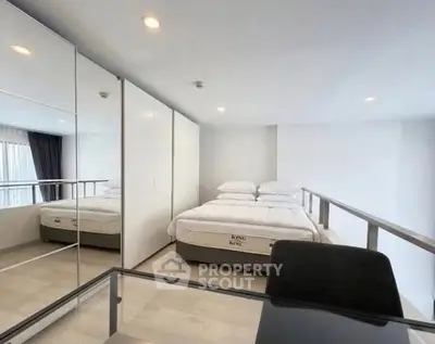 Modern bedroom with king-size bed and mirrored wardrobe in a stylish apartment.