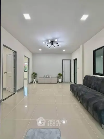 Spacious modern living room with sleek tile flooring and stylish lighting