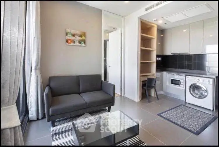 Modern living room with sleek kitchen appliances and stylish decor