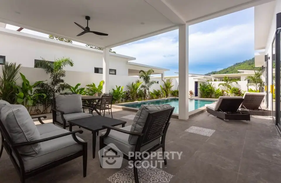 Luxurious outdoor patio with pool and mountain view, perfect for relaxation and entertaining.