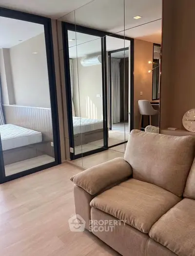 Modern living room with mirrored walls and cozy beige sofa in stylish apartment
