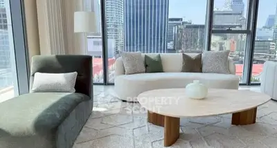 Luxurious living room with modern furniture and stunning city view.