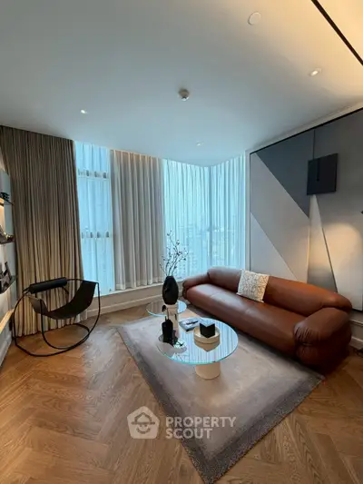 Modern living room with sleek furniture and large windows offering a stunning city view.