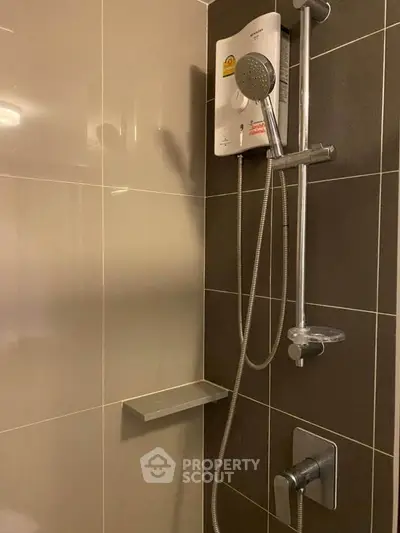 Modern bathroom shower with sleek design and water heater in contemporary apartment.