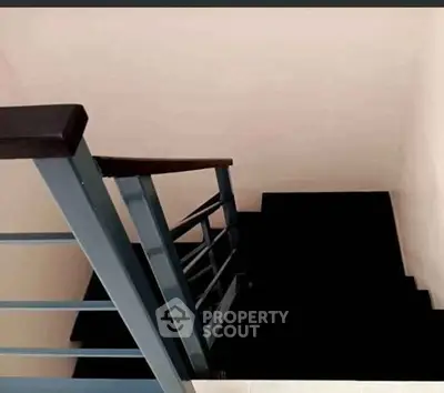 Modern staircase with sleek metal railing in a contemporary home interior.