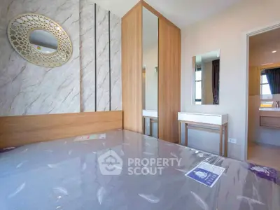 Modern bedroom with stylish decor and mirrored wardrobe in a contemporary apartment.