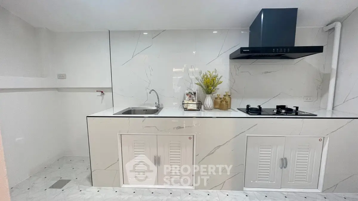 Modern kitchen with sleek marble countertops and gas stove