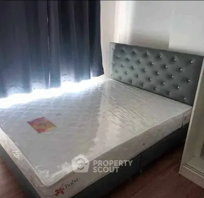 Cozy bedroom with stylish upholstered bed and natural light