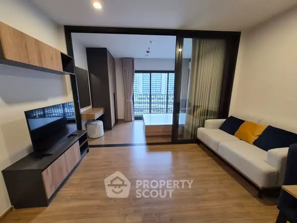 Modern living room with sleek furniture and balcony view in urban apartment