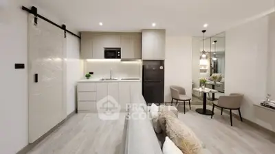 Modern open-plan living room and kitchen with sleek design and cozy seating area.
