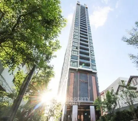 Stunning high-rise building with modern architecture and lush greenery, perfect for urban living.