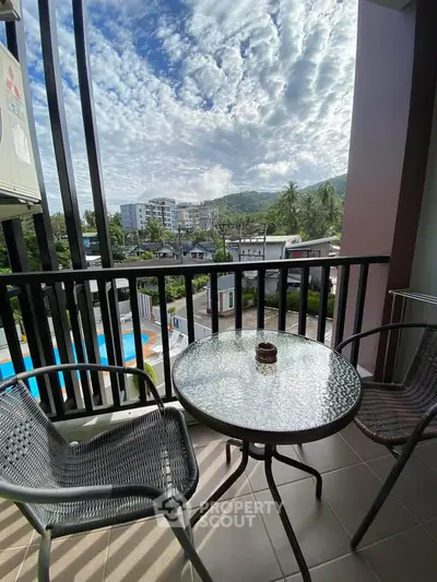 Charming balcony with scenic view and cozy seating, perfect for relaxation.