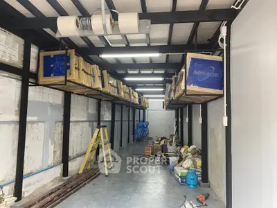 Spacious industrial storage area with high ceilings and organized shelving