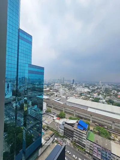 Stunning cityscape view from high-rise building with modern glass facade.