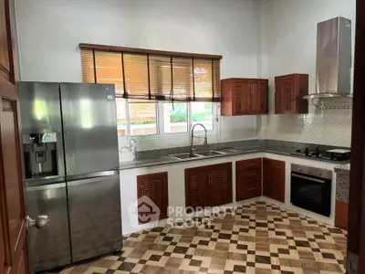 Spacious kitchen with modern appliances and stylish cabinetry in a bright, airy setting.