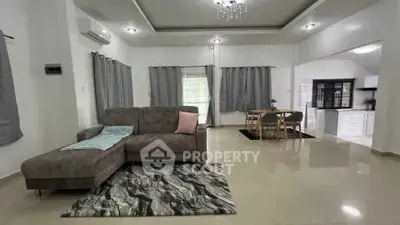 Spacious modern living room with elegant decor and open layout, perfect for family gatherings.