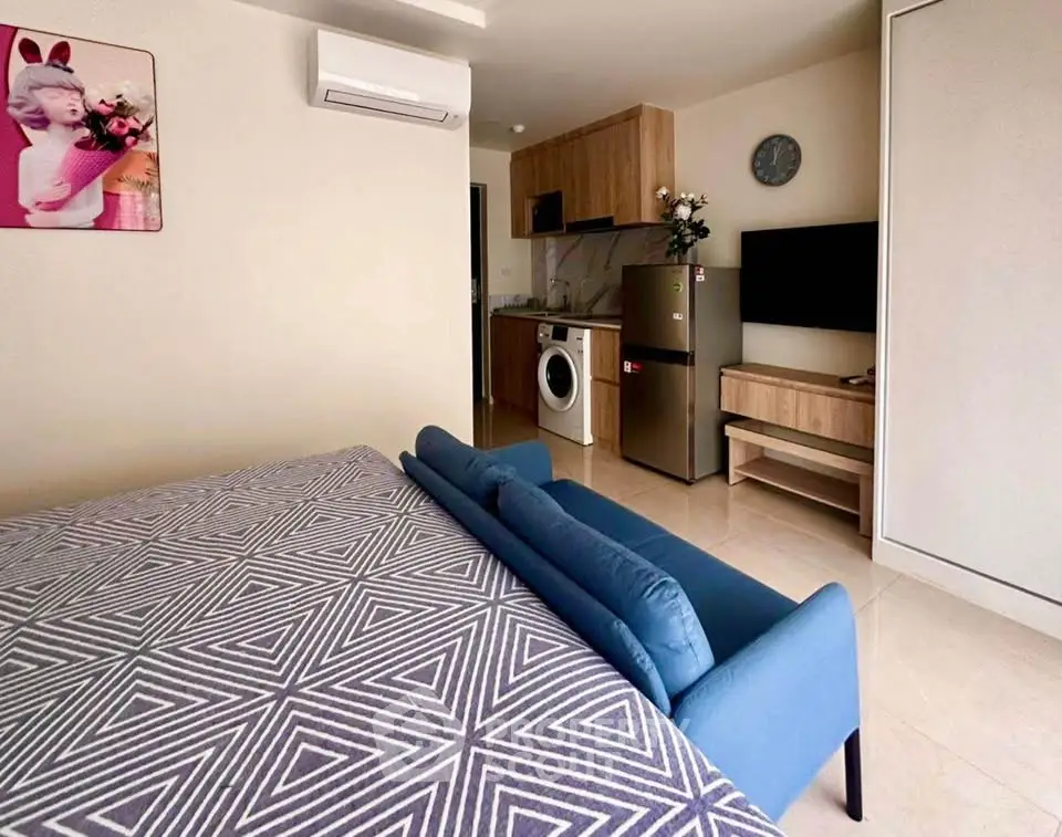 Modern studio apartment with cozy living area and compact kitchen