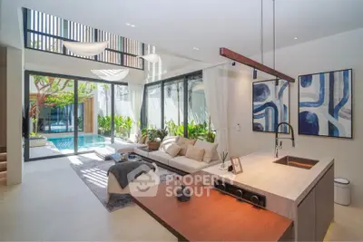 Luxurious open-plan living room with pool view and modern decor