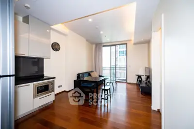 Modern open-plan living room with sleek kitchen and balcony access, featuring hardwood floors and contemporary design.