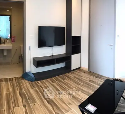 Modern living room with sleek TV setup and stylish wooden flooring
