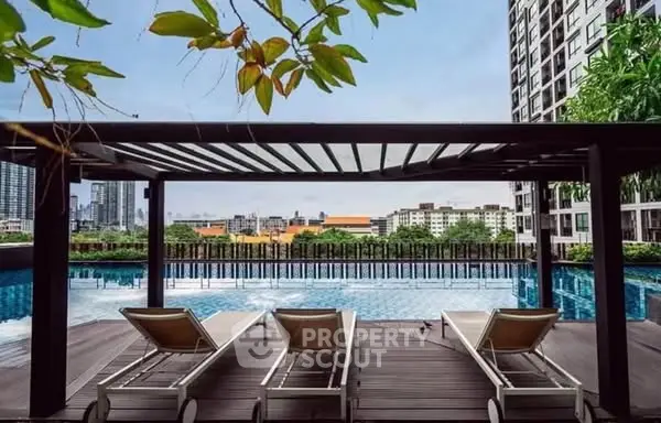 Luxurious rooftop pool with city skyline view and modern lounge chairs.