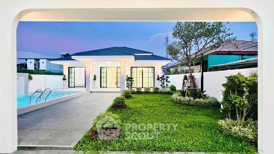 Stunning modern home with lush garden and inviting pool, perfect for luxurious living.