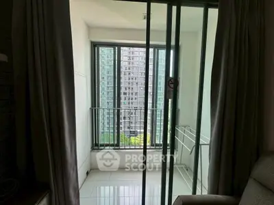 Modern apartment balcony with sliding glass doors and city view