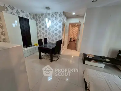 Modern living room with elegant wallpaper and dining area, featuring sleek furniture and stylish lighting.