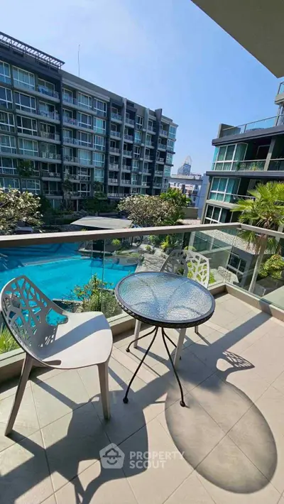 Modern balcony with pool view in luxury apartment complex